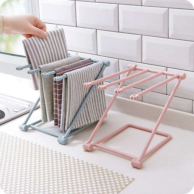 Foldable sink dishcloth rack mounted beside a kitchen sink