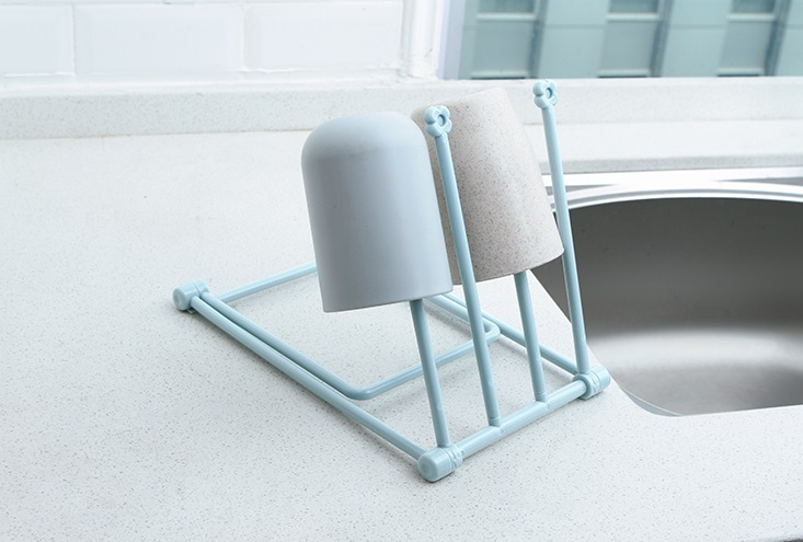 Punch-free adhesive mounting detail for the sink rack