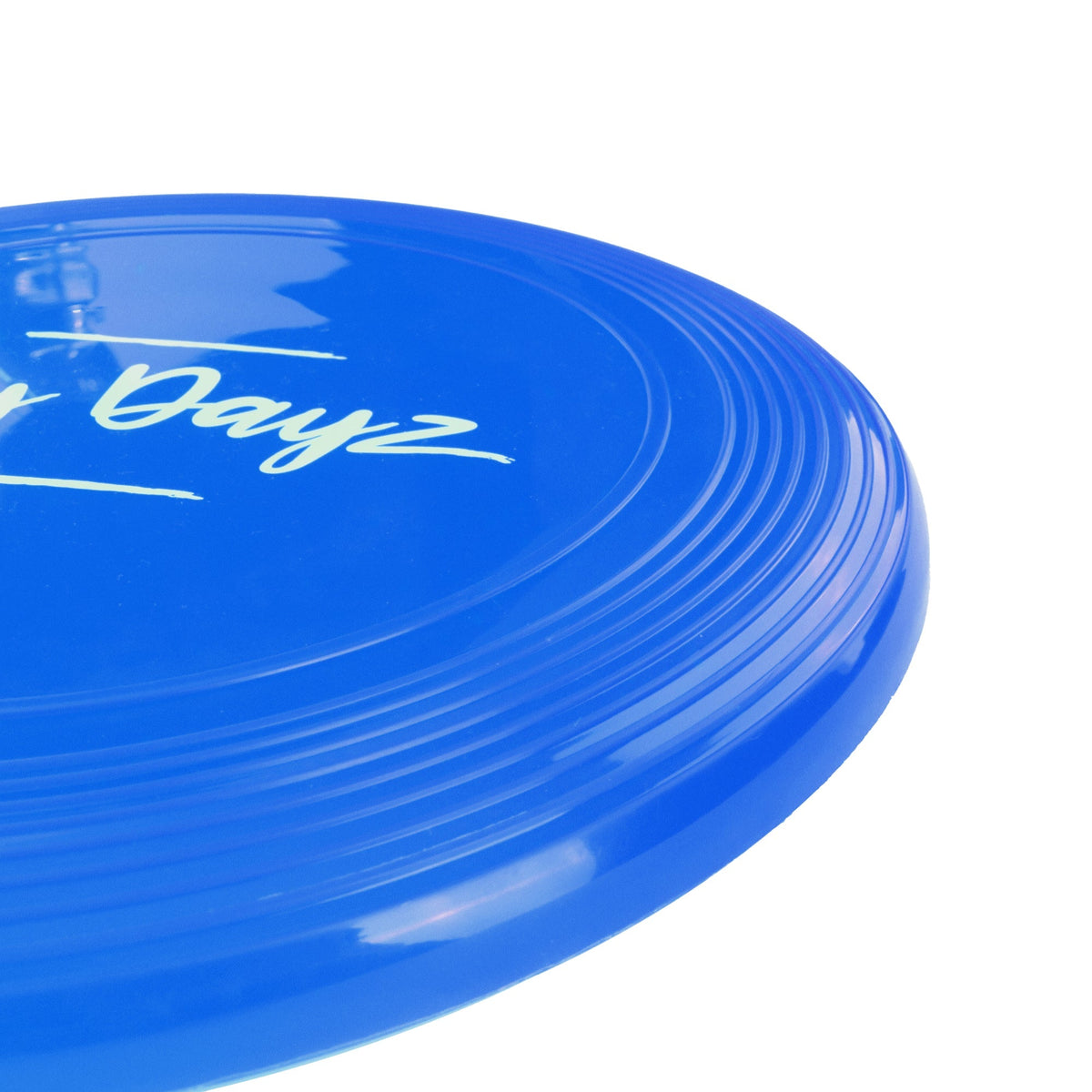 Close-up of the blue flying disc's textured grip edge