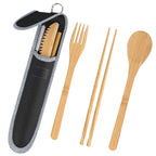 Bamboo travel utensils arranged beside a black carry pouch