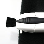 Pocket glasses cleaning brush in use on a lens