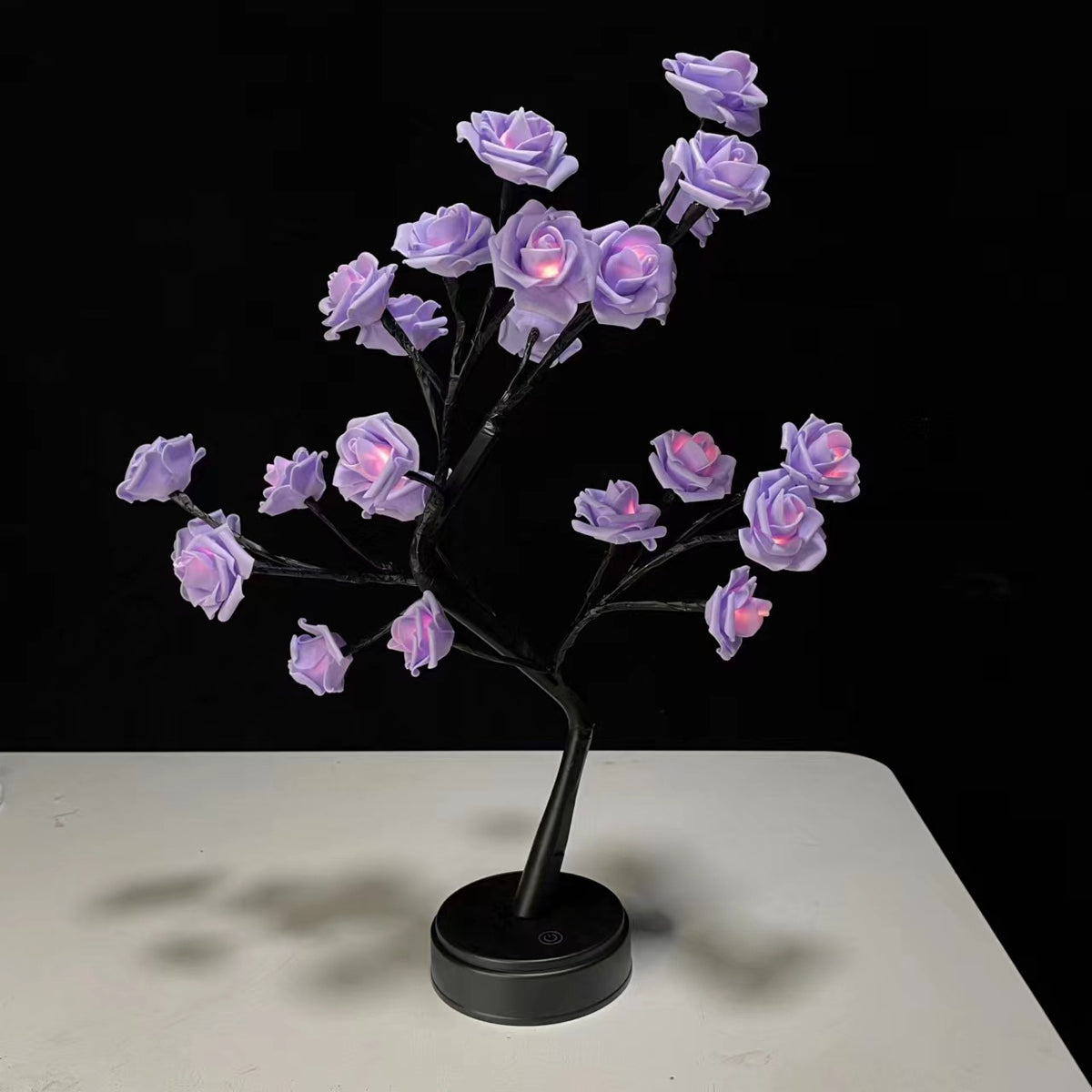 Black rose tree lamp with purple illuminated flowers