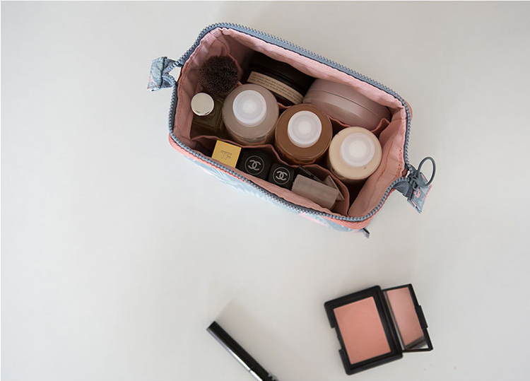Compact Travel Toiletry Pouch shown open with toiletries